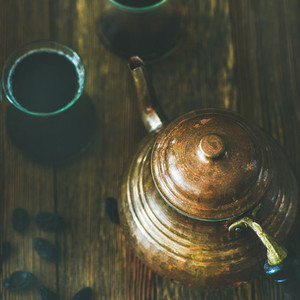 Oriental teapot  black tea in glasses and raisins  square crop