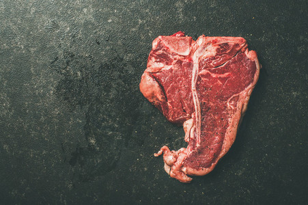 Close up of fresh raw beef meat porterhouse steak copy space
