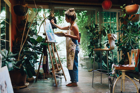 Woman painter painting in her painting studio