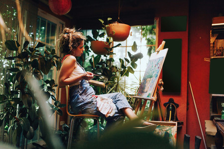 Woman painter painting in her painting studio