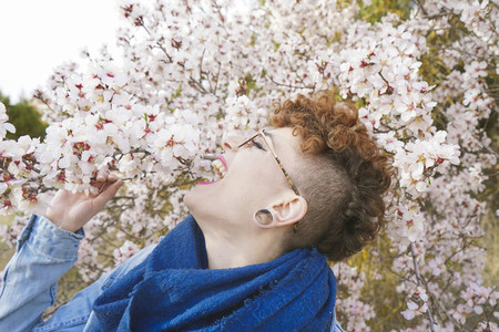Young redhead woman surrounded by flowers