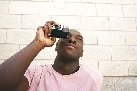 Young man taking shots with an analog camera