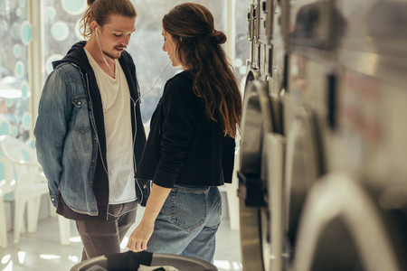 Couple standing in a laundry room