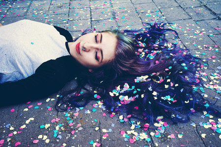 Cool young woman surrounded by confetti