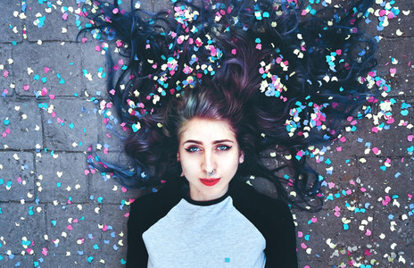 Cool young woman surrounded by confetti