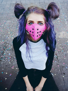 Young punk woman wearing a pink mask