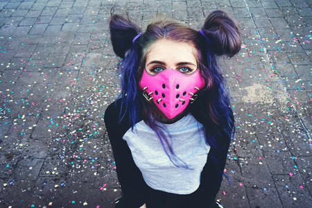 Young punk woman wearing a pink mask