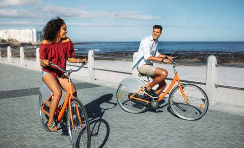 Couple riding bicycles in street