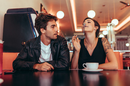 Couple sitting at a diner and having fun