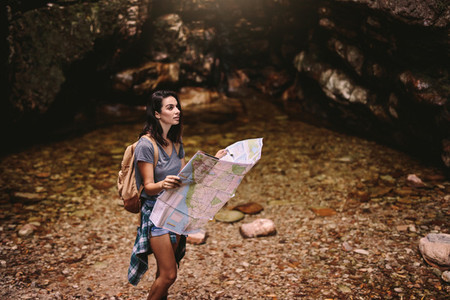 Female hiker with navigation map looking away