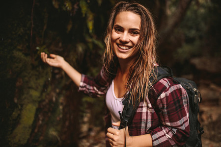 Beautiful woman enjoying hiking in forest