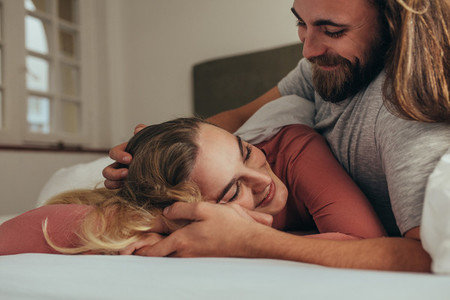 Couple in bed spending time together sharing love