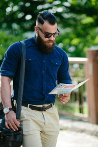 bearded man looking at a map
