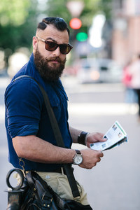 bearded man with a map in hand