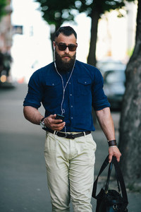 bearded man goes and listens to music
