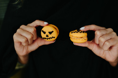 woman holding a biscuit for Halloween