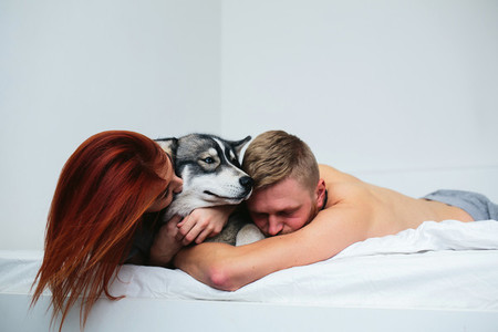 Young adult couple lying on bed