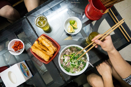 Girl eating Vietnamese noodle
