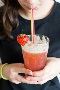 Girl sipping strawberry lemonade