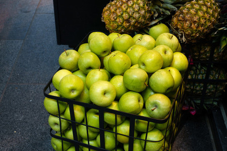 Green apples in shopping trolley