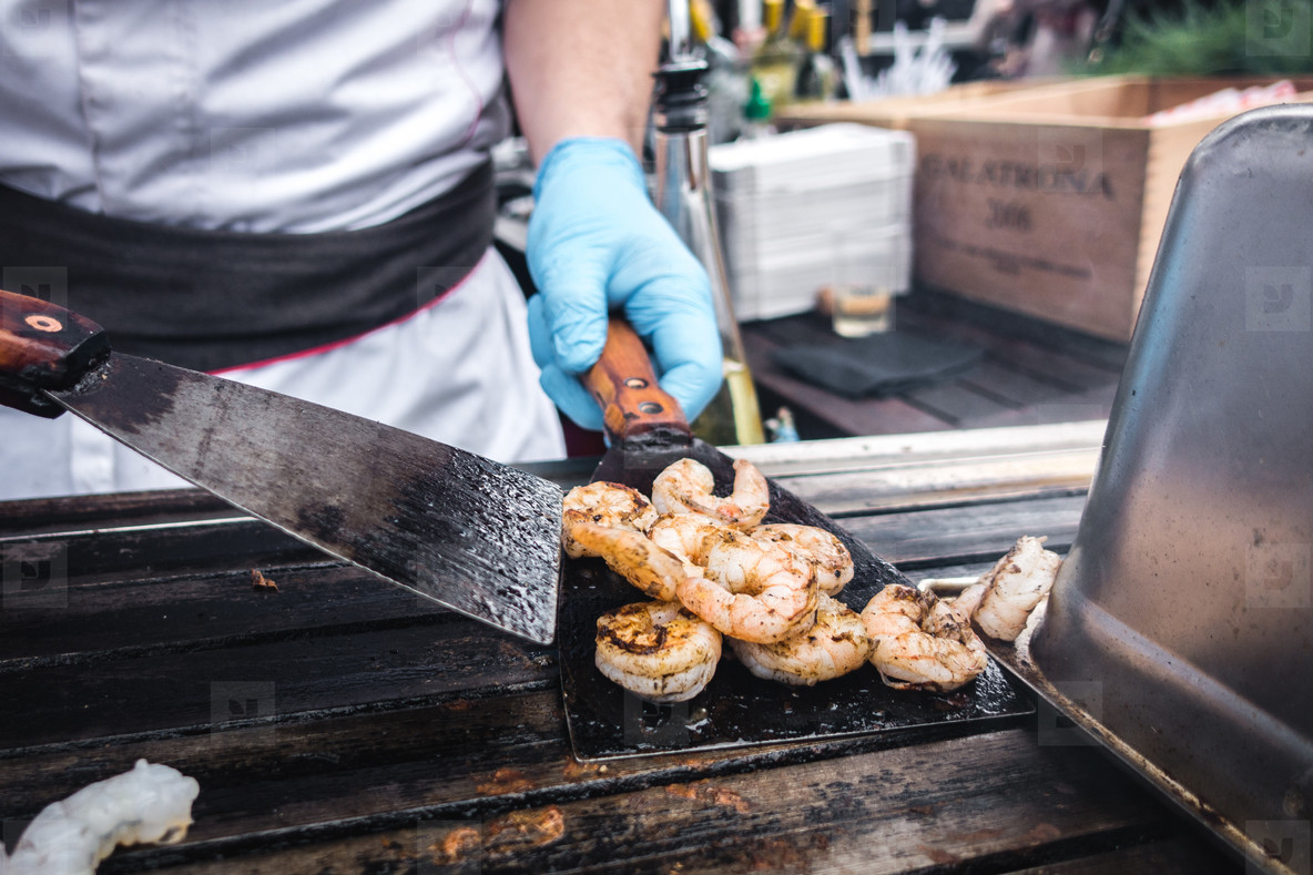 Grilling prawns at market