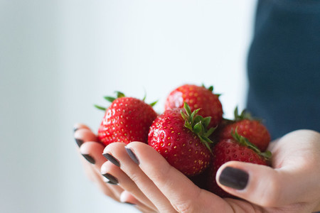 Lady holding fresh strawberries