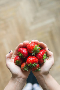 Lady holding fresh strawberries