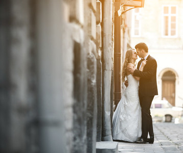 Lovely wedding couple kissing in the city