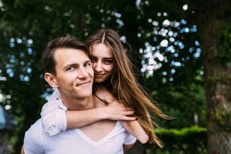 Young adult brunette man and woman in the park