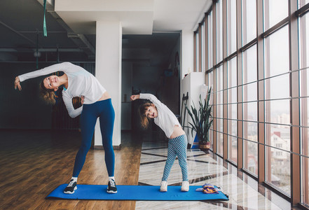 Two girls of different ages makeing yoga