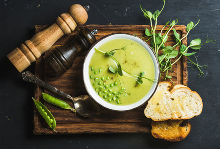 Fresh homemade pea cream soup served with grilled bread