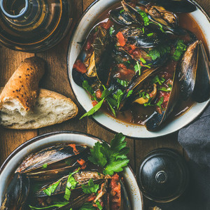 Belgian boiled mussels in tomato sauce with parsley  square crop