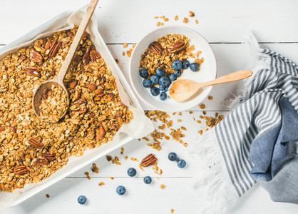 Oat granola with pecan nuts yogurt and blueberry in bowl