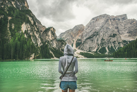 Young woman traveller standing and looking at Lago di Braies