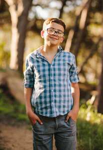 Smiling boy standing in a park