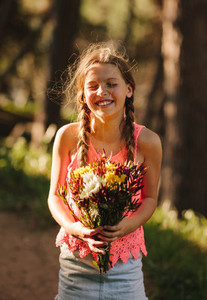 Portrait of a girl holding a bouquet of flowers