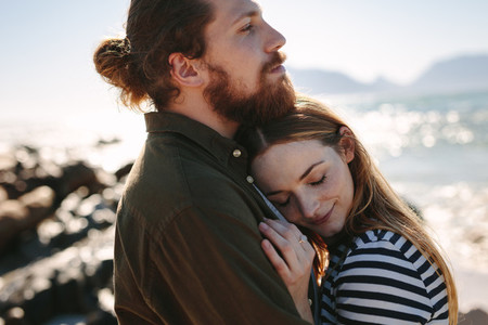 Affectionate couple embracing outdoors on beach