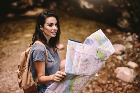 Beautiful woman hiker with a map