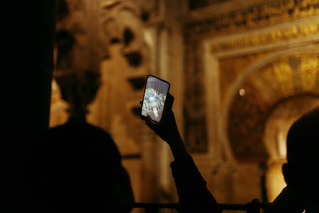 Young woman taken a photo with her phone to the mosque