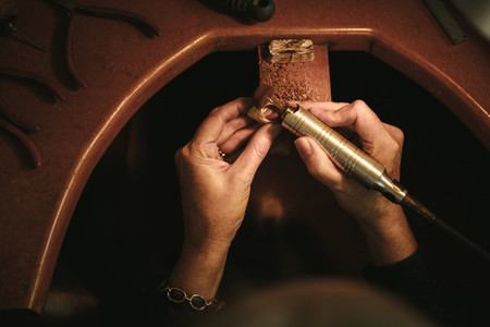 Jeweler hands polishing a ring