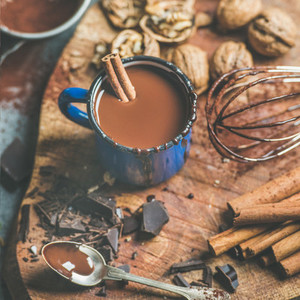 Making rich hot chocolate with cinnamon and walnuts  square crop