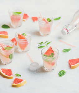 Cold refreshing summer alcohol cocktail with fresh grapefruit in glasses