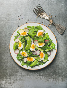 Healthy spring green salad with vegetables pea and boiled egg