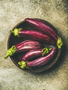 Flat lay of fresh raw Fall harvest purple eggplants or aubergines