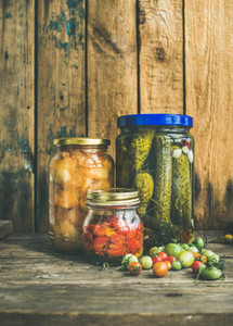 Autumn seasonal pickled vegetables and fruit in jars  copy space