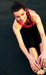 Above view of woman stretching hamstrings on floor