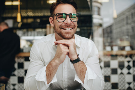 Smiling businessman sitting in a restaurant