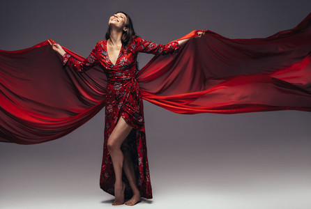 Beautiful woman in flying silk dress