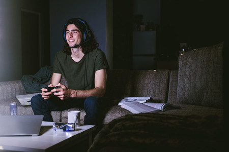 Student taking break from studies paying video game