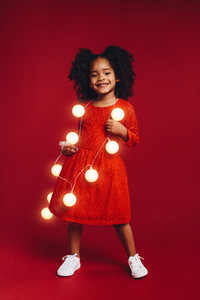 Little girl wearing garland of led bulbs